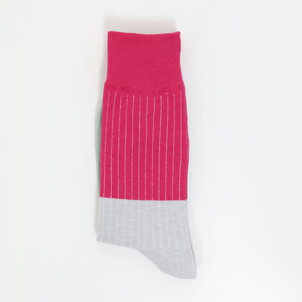 A single crew sock with a vibrant pink upper section featuring thin white vertical pinstripes and a light gray toe section, displayed flat against a clean white background.