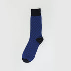 A single blue and black patterned crew sock displayed vertically against a clean, light gray background.