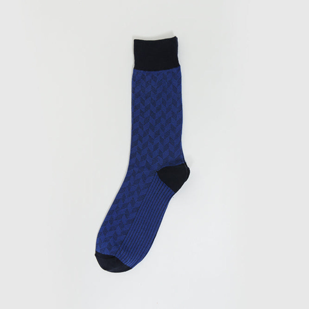 A single blue and black patterned crew sock displayed vertically against a clean, light gray background.