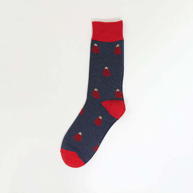 A single navy blue crew sock with a repeating pattern of small red Christmas trees and white star toppers, featuring solid red heels, toes, and cuffs, displayed against a plain white background.