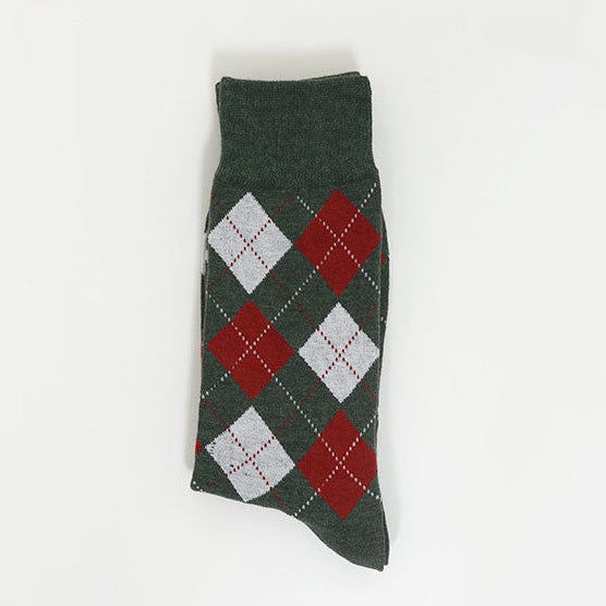 A single dark green argyle sock with red and white diamond patterns, photographed flat against a plain white background.