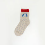 A single light beige sock with a repeating blue wave pattern, featuring a blue and white owl graphic on the cuff with a red top band, shown against a plain white background.