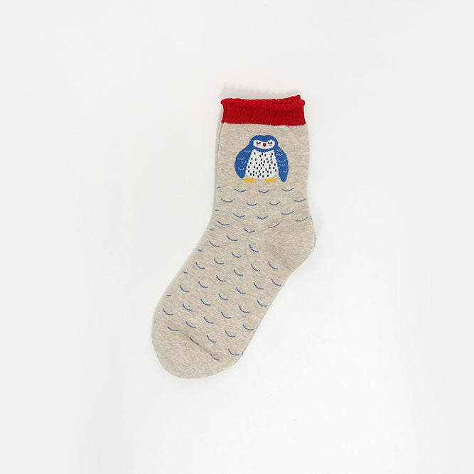 A single light beige sock with a repeating blue wave pattern, featuring a blue and white owl graphic on the cuff with a red top band, shown against a plain white background.