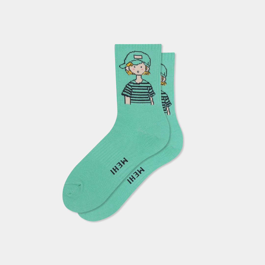 A pair of mint green crew socks featuring a cartoon illustration of a person wearing a striped shirt and cap on the upper cuff, with the word 'MEHI' printed vertically in black on the sole of one sock, set against a light gray background.