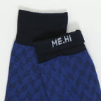 A pair of folded knit socks in blue and black with a geometric pattern, featuring the text 'ME.HI' knitted in white on the black cuff.