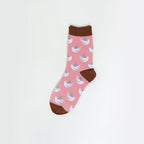 A single pink crew sock with a repeating pattern of white doves and brown accents on the cuff, heel, and toe, displayed against a clean white background.