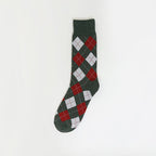 A pair of knit socks with a light pink ribbed cuff and a green and white vertically striped body, featuring the text 'ME,HI' embroidered on one cuff.