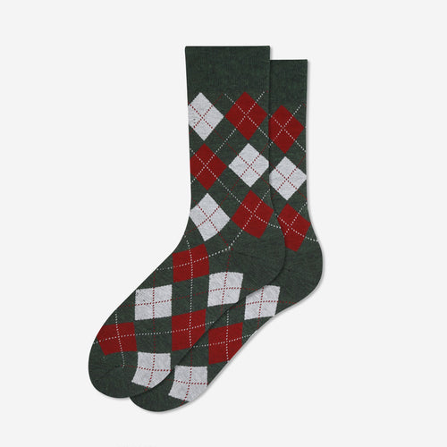 A pair of dark green crew socks with an argyle pattern in red and white, displayed against a light gray background.