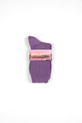 A pair of purple crew socks folded together with a pink paper band label that reads 'SEOUL IN SOCKS'.
