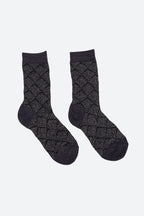 A pair of dark charcoal gray crew socks with a textured diamond argyle pattern and solid dark cuffs, heels, and toes, displayed on a light gray background.