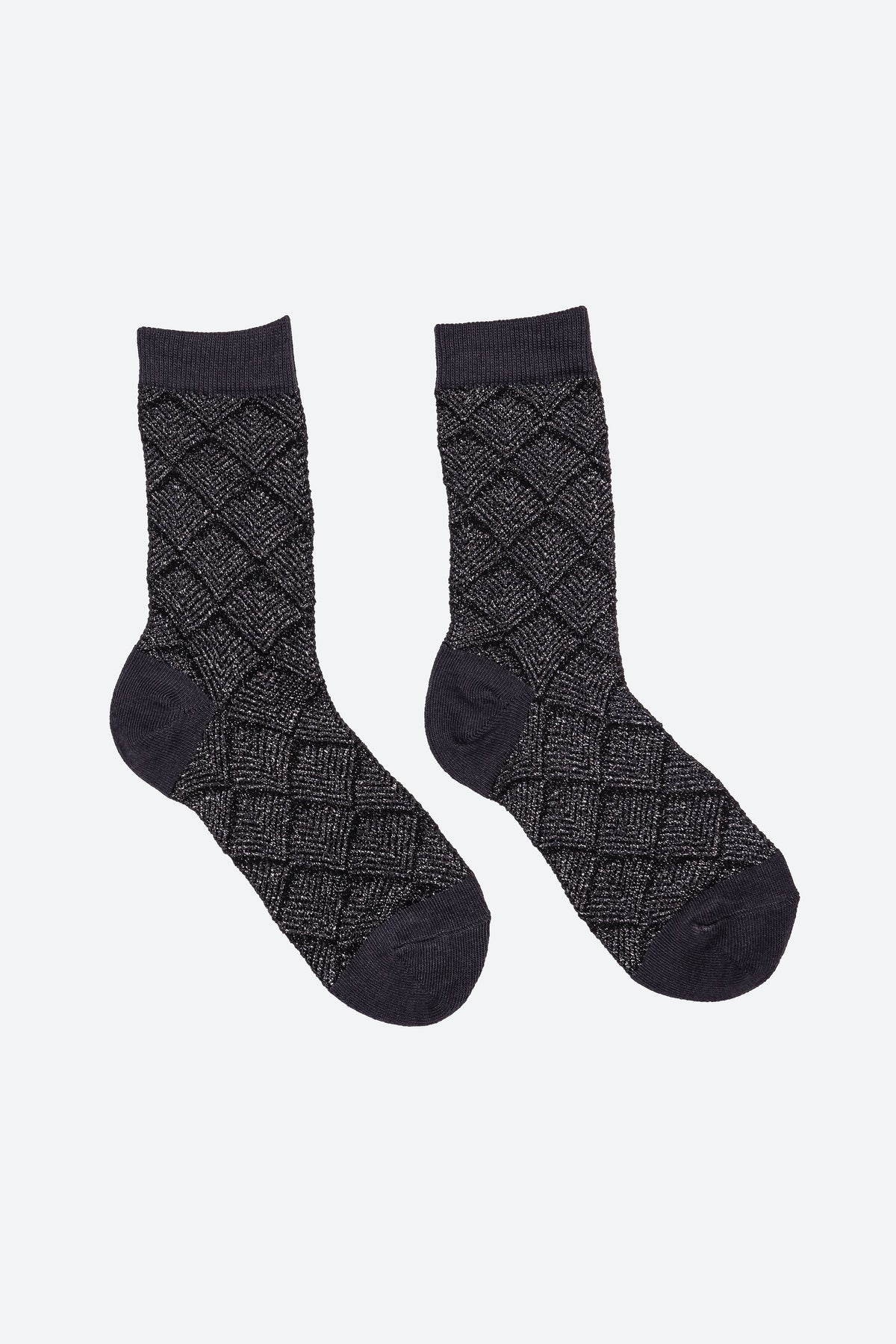 A pair of dark charcoal gray crew socks with a textured diamond argyle pattern and solid dark cuffs, heels, and toes, displayed on a light gray background.