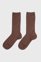 A pair of solid brown crew socks displayed flat against a light gray background.