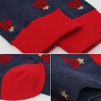 A close-up collage of a pair of navy blue and red knit socks with a festive pattern of red fireworks and small gold stars.
