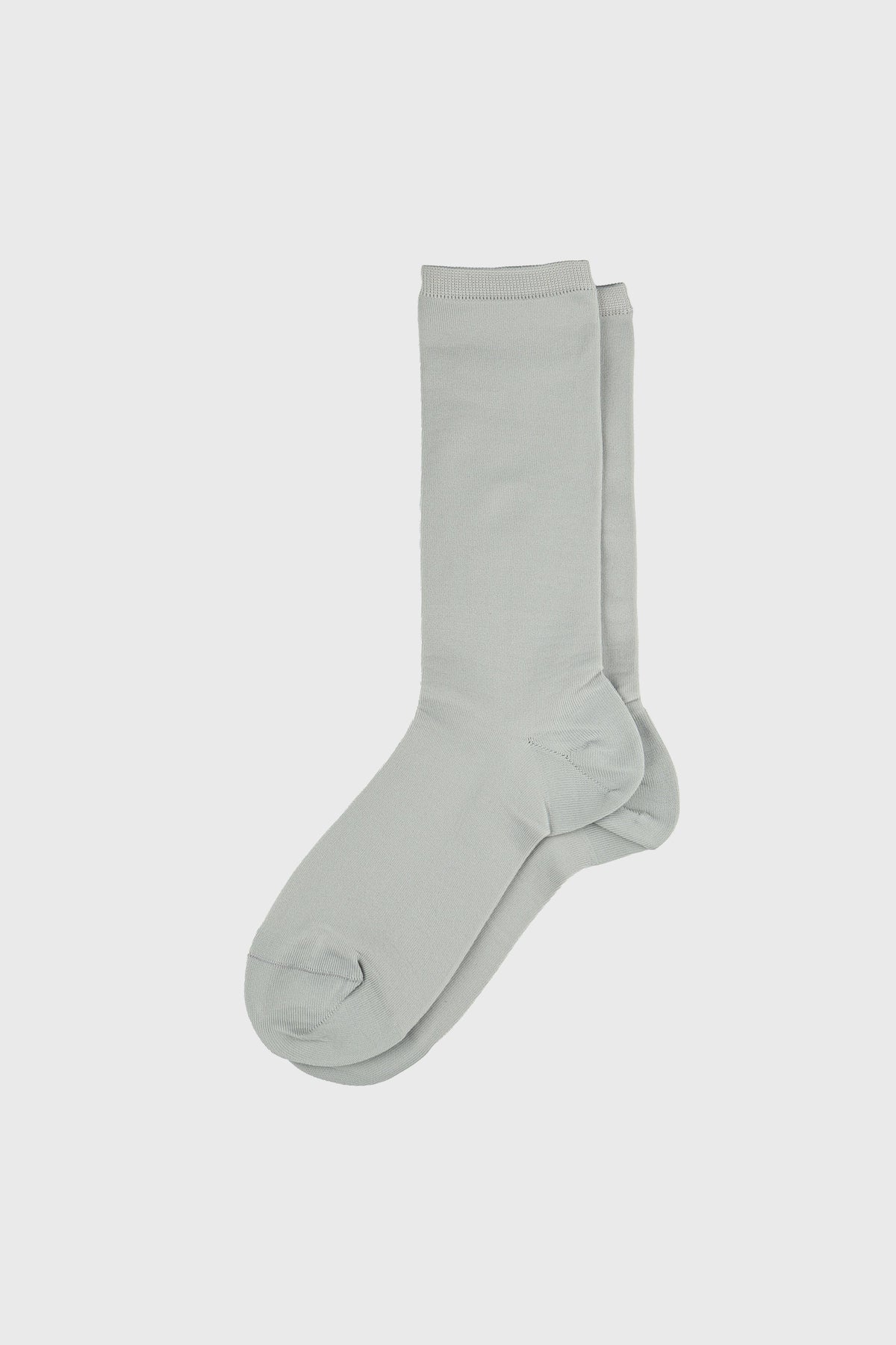 A pair of light sage green crew socks displayed flat against a solid light gray background.