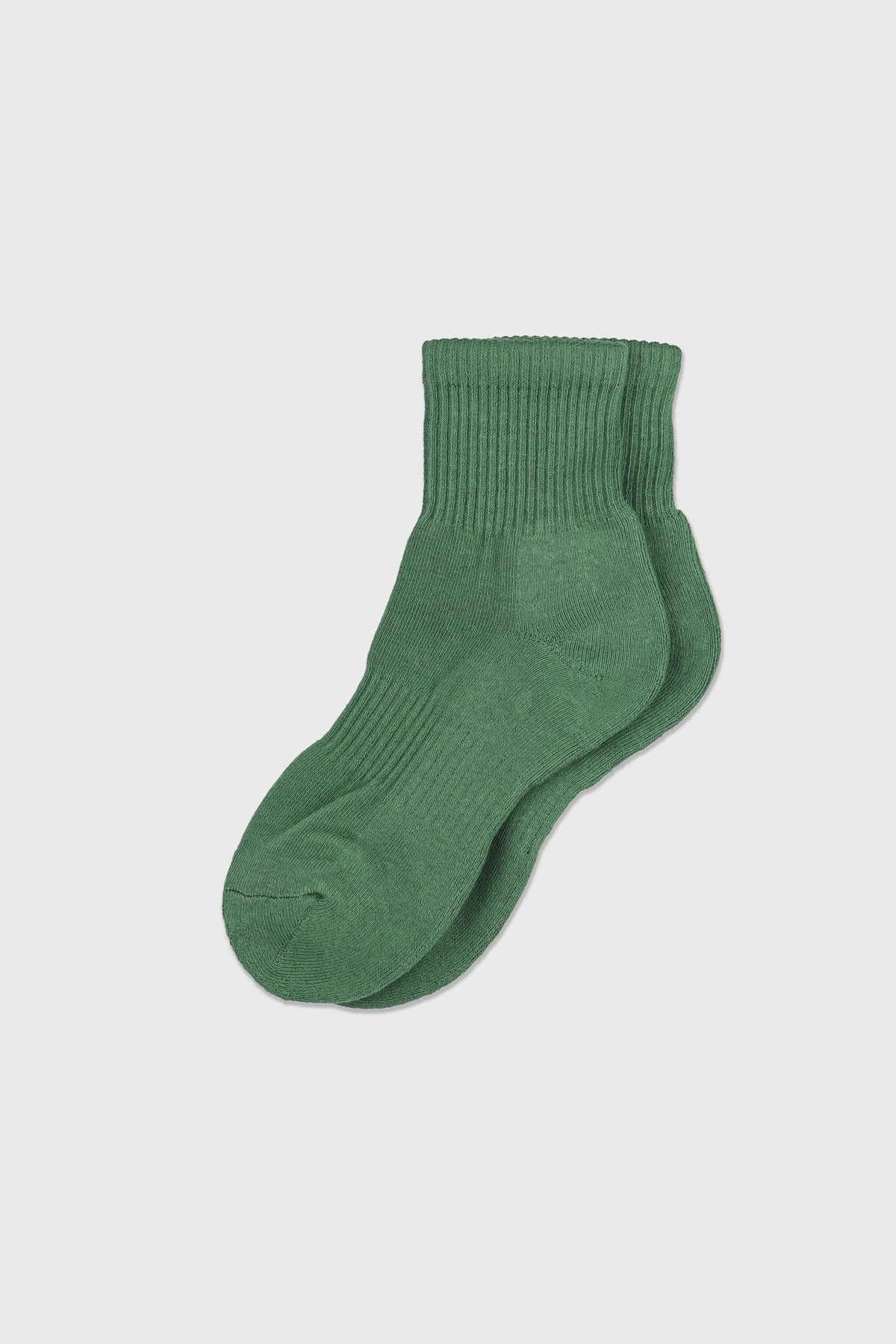 A pair of green crew socks displayed against a light gray background.