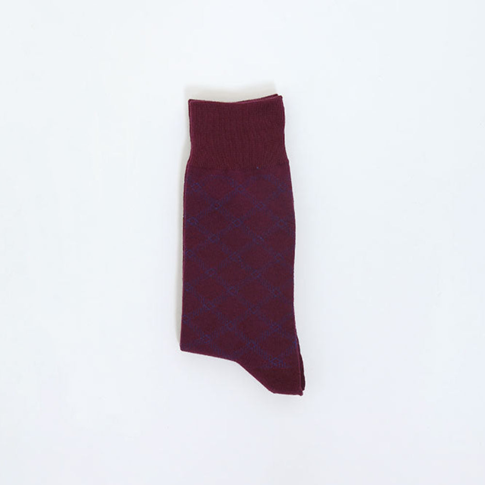A single dark burgundy knit sock with a subtle blue diamond pattern, laid flat on a clean white background.