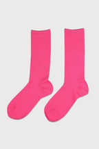A pair of bright pink crew socks displayed flat against a light gray background.